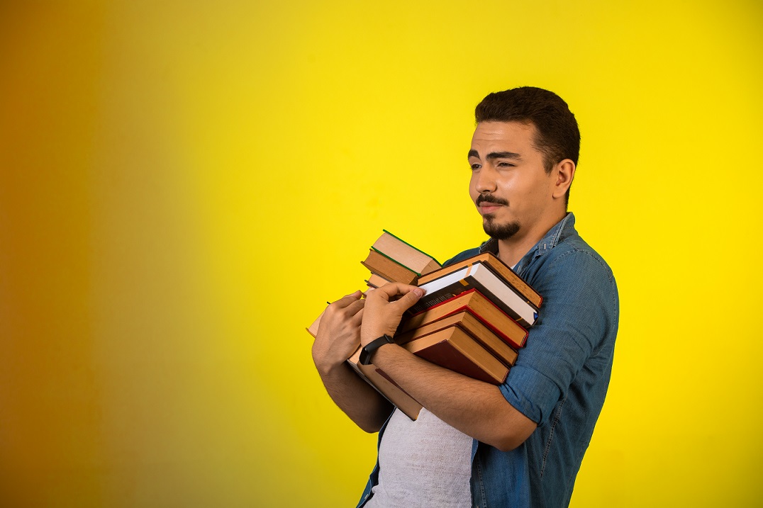 Mexican man carrying books illustrates blog "A Journey Through Chicano Literature"